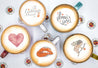  Bundle Love Sticker auf unterschiedlich bunten Kaffeetassen mit Capuccino der Untergrund ist mit Twicky Sticky Logo Stickern bedeckt. 